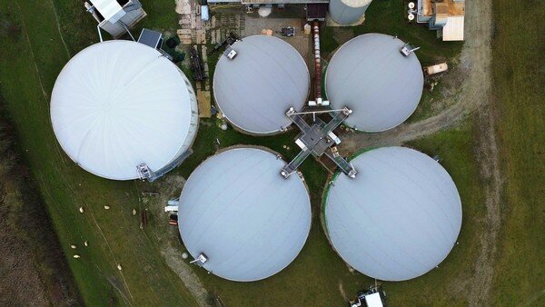 Aerial view of a biogas production plant with five anaerobic digesters